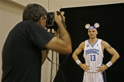 Orlando Magic center Marcin Gortat poses with Mickey Mouse ears on his head during Orlando Magic Media Day.