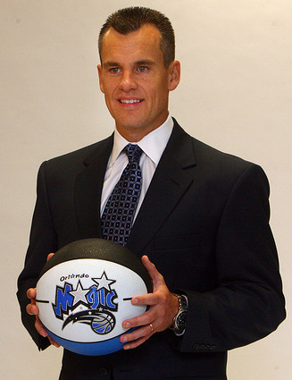 Billy Donovan poses with an Orlando Magic basketball after a press conference announcing his hiring as the team's head coach.