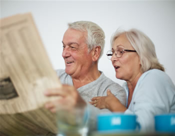 Seniors_couple_reading_newspaper_medium