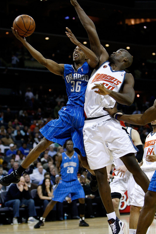 Orlando Magic point guard Rafer Alston tries to shoot a layup around the defense of Charlotte Bobcats center Emeka Okafor in Orlando's 92-80 win over Charlotte on Friday, February 20th, 2009.